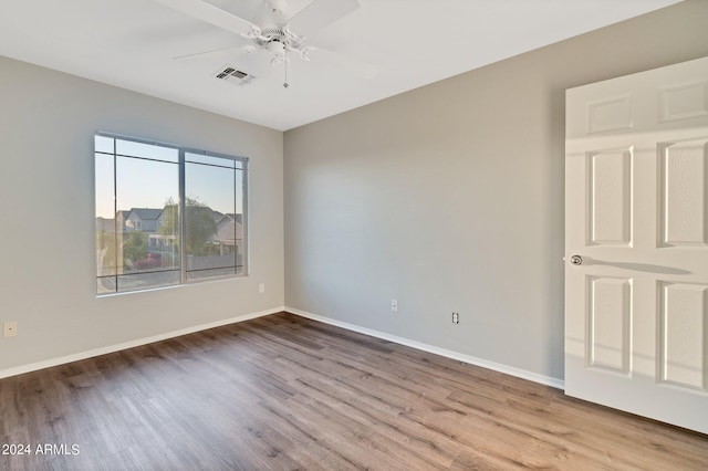 spare room with light hardwood / wood-style flooring and ceiling fan