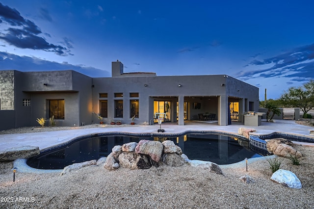 view of pool featuring a patio area and a pool with connected hot tub