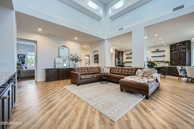 living room featuring recessed lighting, light wood-style flooring, and visible vents