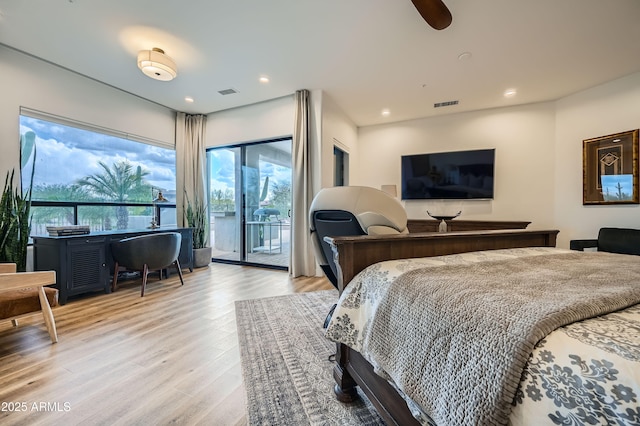 bedroom featuring access to outside, wood finished floors, multiple windows, and visible vents