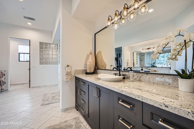 bathroom featuring recessed lighting, visible vents, vanity, and a wealth of natural light