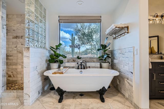 bathroom with a freestanding bath, tile walls, marble finish floor, and walk in shower