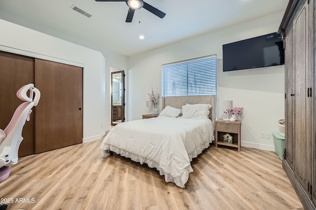 bedroom with recessed lighting, visible vents, light wood-style floors, baseboards, and ensuite bathroom