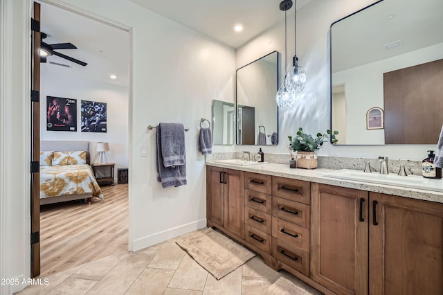 bathroom featuring double vanity, ensuite bath, a sink, and ceiling fan