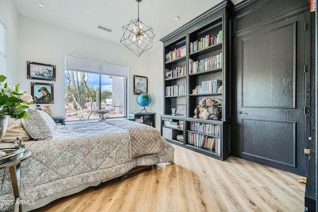 bedroom with recessed lighting, wood finished floors, visible vents, access to exterior, and a notable chandelier