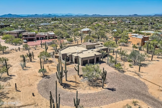 drone / aerial view with view of desert and a mountain view