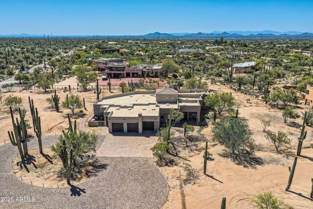 aerial view featuring a desert view and a mountain view