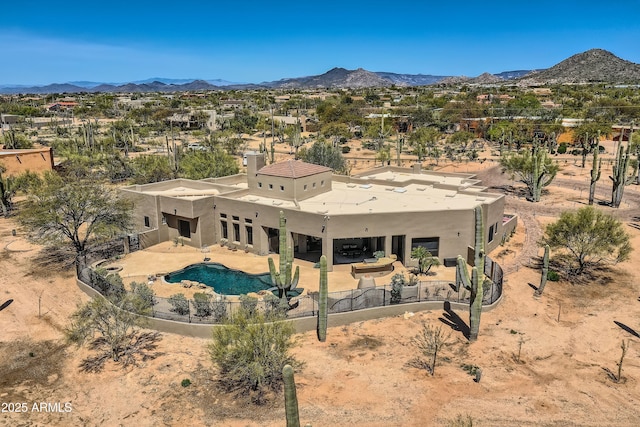 exterior space featuring a fenced backyard, a mountain view, a patio, a fenced in pool, and stucco siding