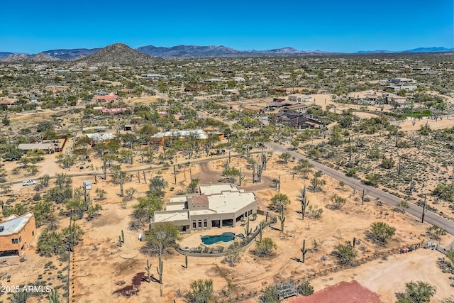 birds eye view of property with view of desert and a mountain view