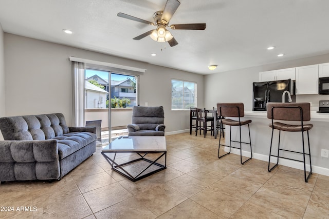 tiled living room featuring ceiling fan