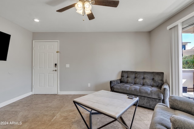 tiled living room with ceiling fan