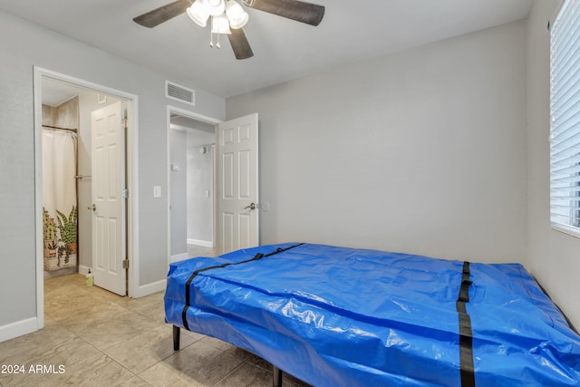 bedroom with ceiling fan, multiple windows, and light tile patterned floors