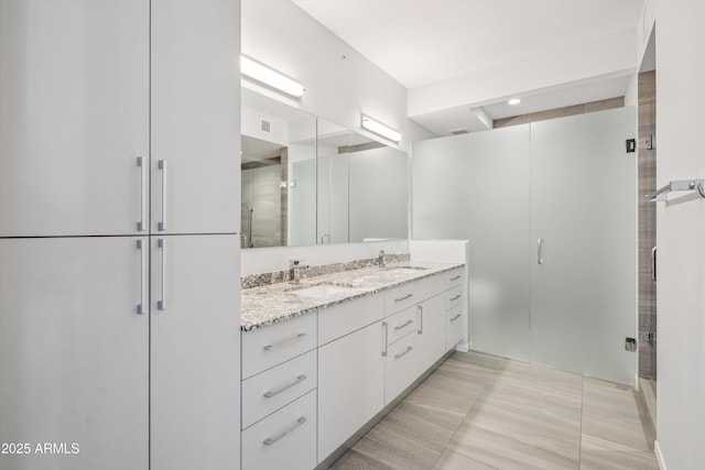 7180 E Kierland Blvd Unit 507, Scottsdale, AZ 85254 - bathroom with double vanity and a shower stall