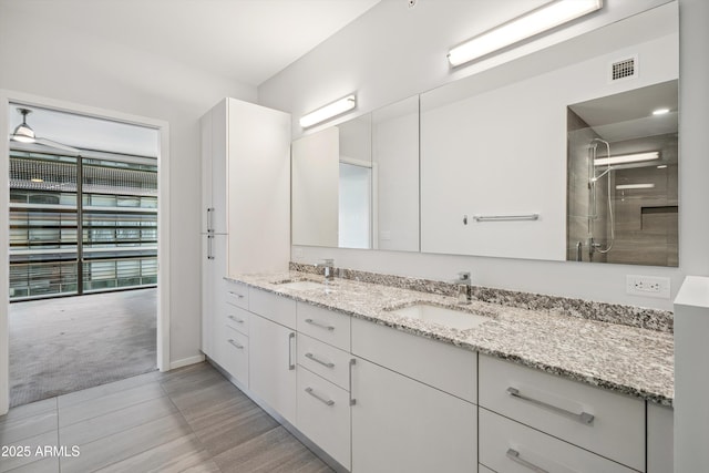 7180 E Kierland Blvd Unit 507, Scottsdale, AZ 85254 - full bath featuring double vanity, a shower, and wood finished floors