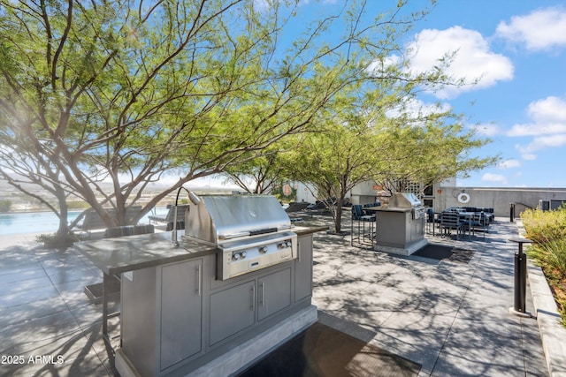 7180 E Kierland Blvd Unit 507, Scottsdale, AZ 85254 - view of patio / terrace with outdoor dining area, area for grilling, and a water view