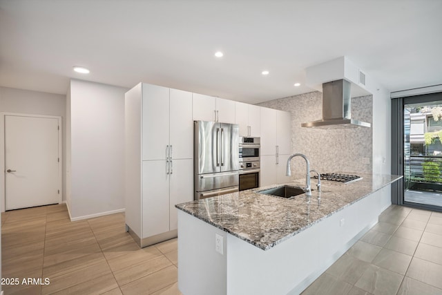 7180 E Kierland Blvd Unit 507, Scottsdale, AZ 85254 - kitchen featuring wall chimney range hood, appliances with stainless steel finishes, light stone countertops, tasteful backsplash, and a peninsula