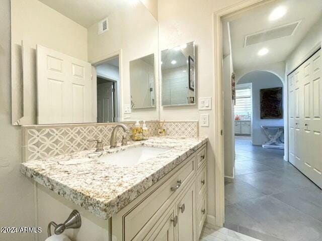 bathroom featuring decorative backsplash and vanity