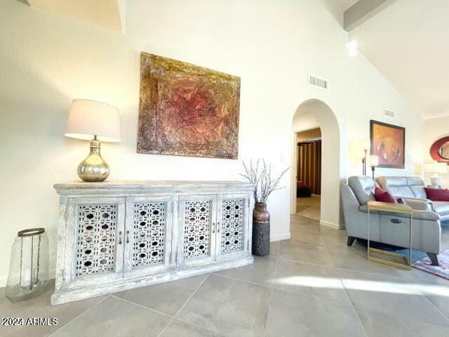 interior space featuring beamed ceiling and high vaulted ceiling