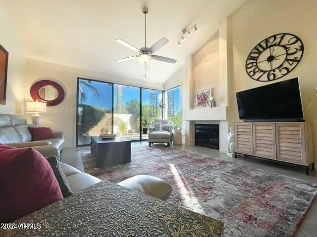 living room with ceiling fan and high vaulted ceiling