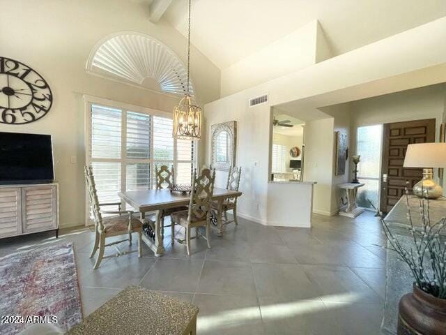 tiled dining space featuring beam ceiling, high vaulted ceiling, and ceiling fan with notable chandelier