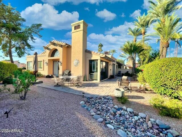 back of property featuring a patio