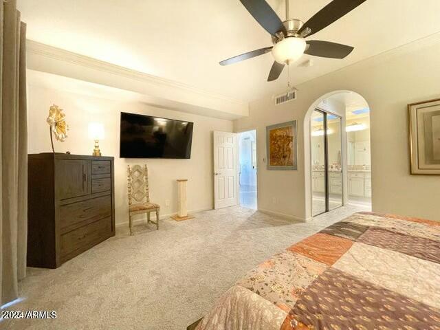 carpeted bedroom with ceiling fan and ornamental molding