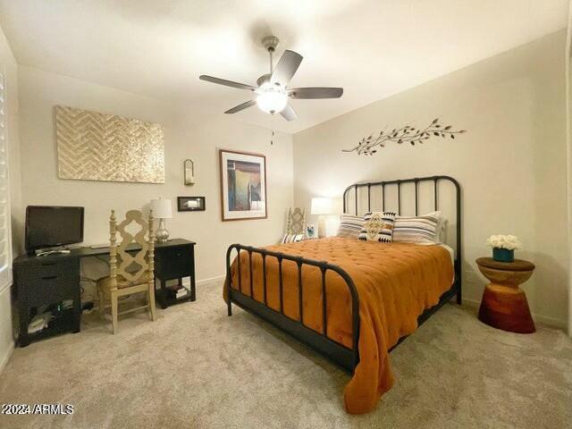 bedroom with light colored carpet and ceiling fan