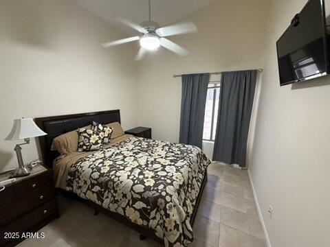 1038 S Palomino Creek Dr, Gilbert, AZ 85296 - bedroom with light tile patterned floors, a ceiling fan, and high vaulted ceiling