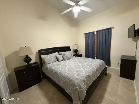 1038 S Palomino Creek Dr, Gilbert, AZ 85296 - bedroom featuring light tile patterned flooring, vaulted ceiling, and ceiling fan