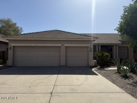 1038 S Palomino Creek Dr, Gilbert, AZ 85296 - view of front of property with concrete driveway, a garage, and stucco siding