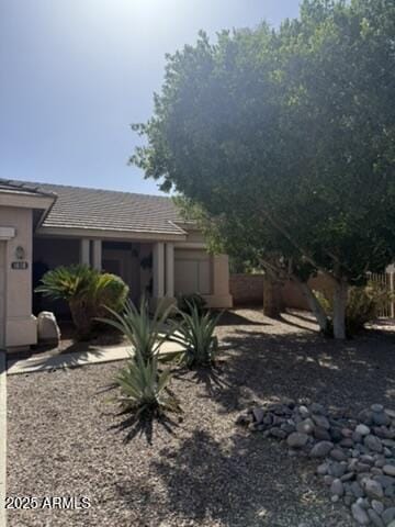 1038 S Palomino Creek Dr, Gilbert, AZ 85296 - view of property exterior with a garage and a tiled roof