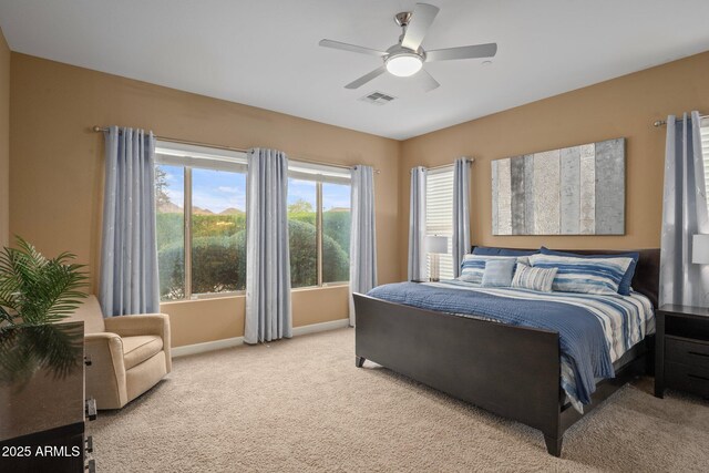 carpeted bedroom with baseboards and a ceiling fan