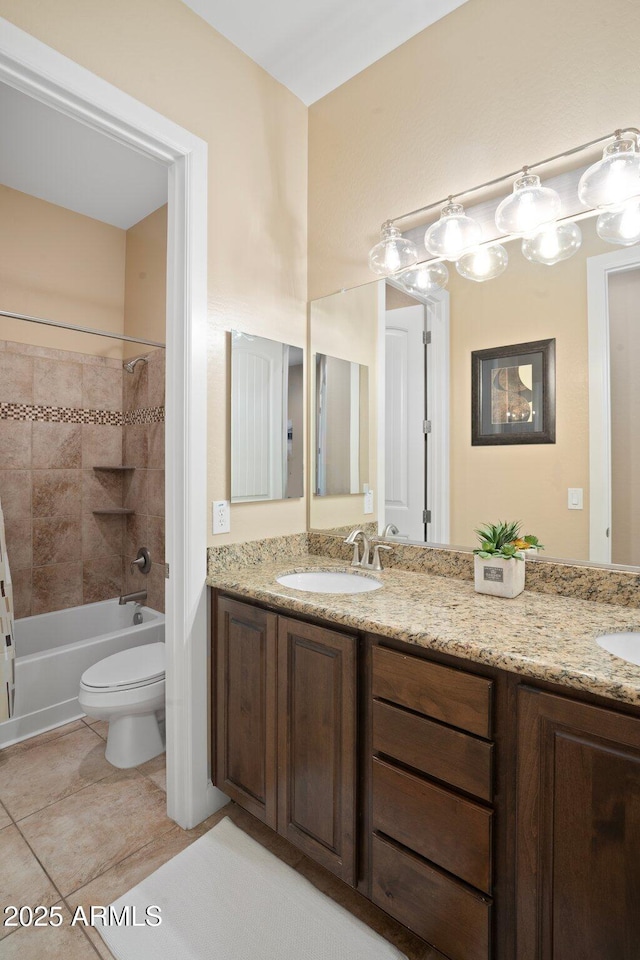 bathroom with double vanity, toilet,  shower combination, and tile patterned floors