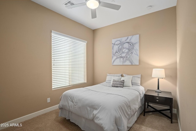 carpeted bedroom with multiple windows, baseboards, and a ceiling fan