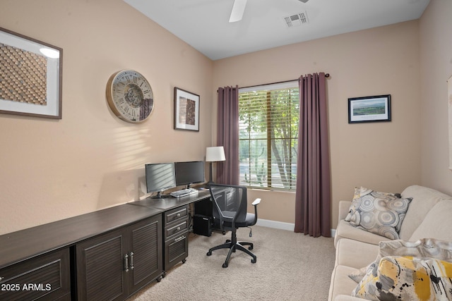 office area featuring light carpet, ceiling fan, and baseboards