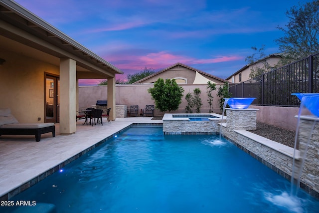 view of swimming pool with a fenced backyard, a patio, and a pool with connected hot tub