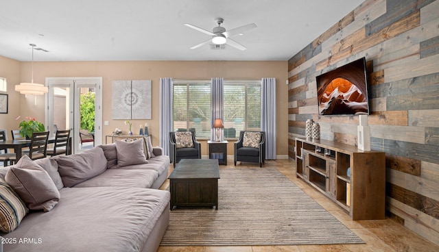 living room with a ceiling fan and light tile patterned floors
