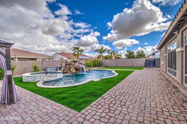 view of swimming pool with a patio, a fenced backyard, a lawn, and a pool with connected hot tub