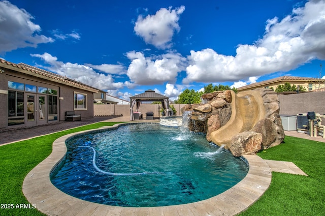 view of swimming pool featuring a patio, a fenced in pool, a fenced backyard, a gazebo, and french doors