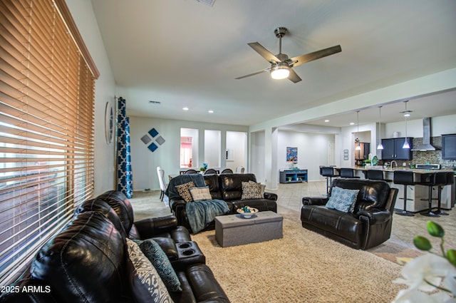 living area featuring recessed lighting, visible vents, and a ceiling fan