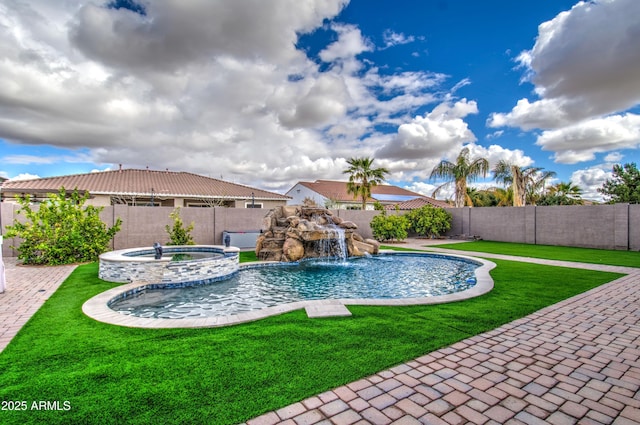 view of pool featuring a pool with connected hot tub, a lawn, and a fenced backyard