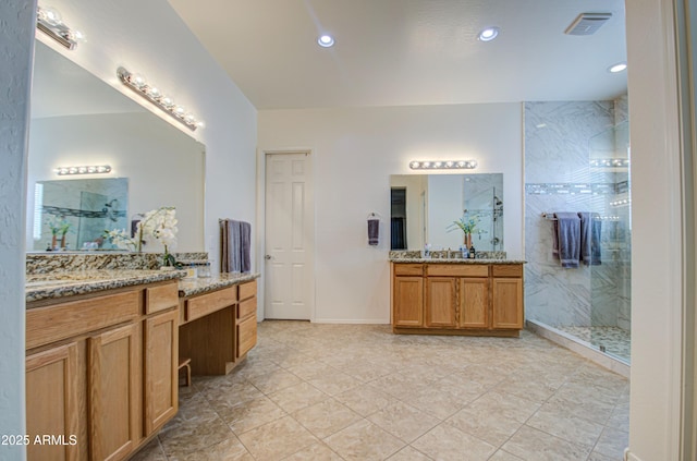 full bathroom with visible vents, a marble finish shower, baseboards, two vanities, and recessed lighting