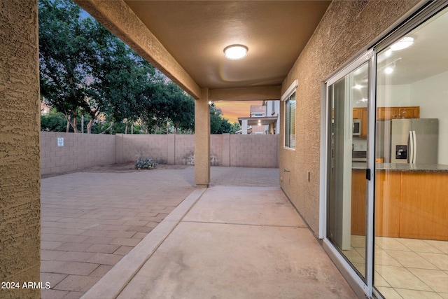 view of patio terrace at dusk