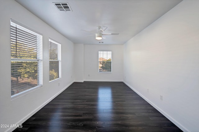 spare room featuring dark hardwood / wood-style floors and ceiling fan