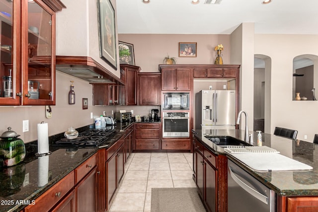 4041 N Silver Ridge Cir, Mesa, AZ 85207 - kitchen with black appliances, dark stone countertops, arched walkways, and glass insert cabinets