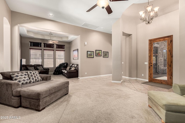 4041 N Silver Ridge Cir, Mesa, AZ 85207 - living room with light colored carpet, ceiling fan, light tile patterned floors, a tray ceiling, and a chandelier