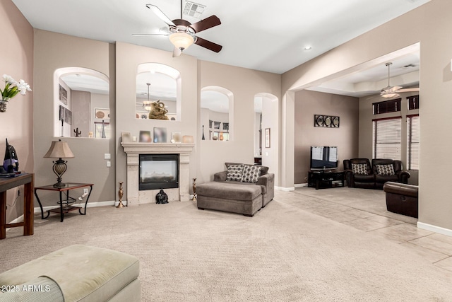 4041 N Silver Ridge Cir, Mesa, AZ 85207 - living area featuring a ceiling fan, arched walkways, a glass covered fireplace, and carpet floors