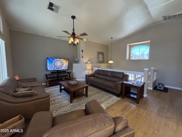 living area with lofted ceiling, light wood-style floors, ceiling fan, and baseboards