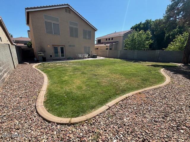 rear view of house with french doors, stucco siding, and a patio