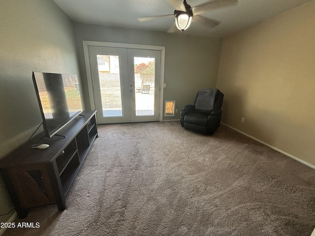 sitting room featuring french doors, carpet floors, a ceiling fan, and baseboards